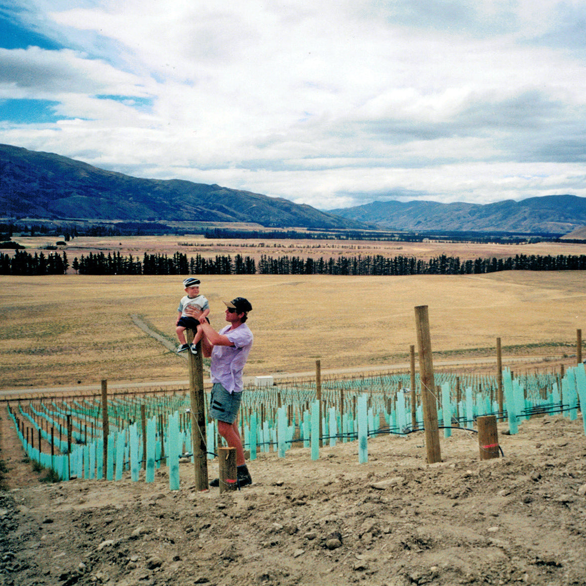 Rudi with son Roman and the first grapeines planted in Bendigo, Central Otago